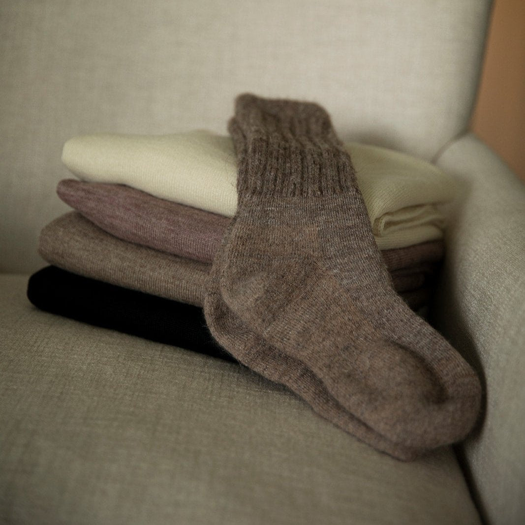 Pair of oat socks ethically made from sustainably sourced alpaca in Peru.
