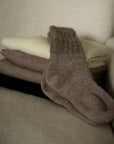 Pair of oat socks ethically made from sustainably sourced alpaca in Peru.