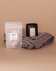 Imagine Gift Set. A Gift Bundle curated from women owned brands. Seen here, Self-Love bath salts, luxury Vellie Candle in the scent Hope and a Vellie wrap folded.