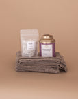 Soulshine Gift Bundle. Folded at the bottom is an oat wrap made from 100% baby alpaca and on top Dream Bath Soak by The Bohemian Box Shop and Chamomile Lavender tea by Tea Heaven.