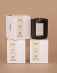 Moody shot of 3 stacked candle boxes by Vellie of the luxury candle scent Hope.. Each candle is hand poured with soy & coconut wax.