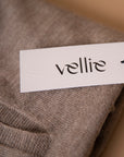 Hangtag white and black design showcasing Vellie brand in bold black font. Attached here to a Vellie Wrap in the color Oat.
