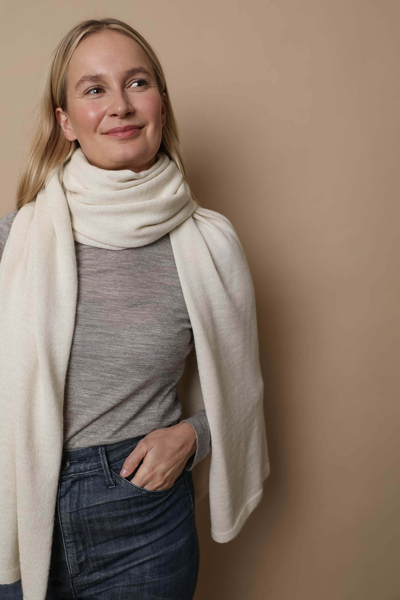 Model wearing an Ivory wrap. Made from 100% fair-trade baby alpaca fiber. Styled here as a scarf.