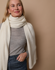 Model wearing an Ivory wrap. Made from 100% fair-trade baby alpaca fiber. Styled here as a scarf.