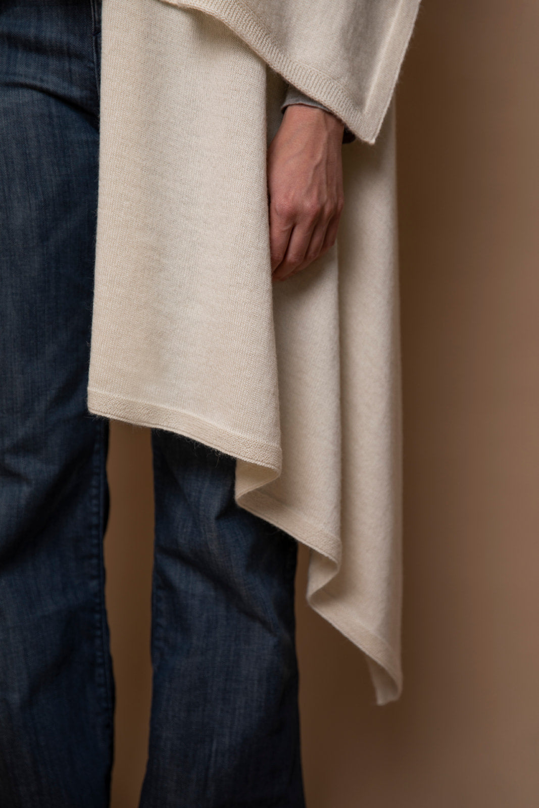 Close-up of Vellie ivory wrap, highlighting the soft, luxurious texture of 100% fair-trade baby alpaca fiber. Crafted to RAS (Responsible Alpaca Standard), Fair Trade Peru, and Oeko-Tex Standard 100 standards for exceptional quality and sustainability.