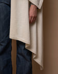 Close-up of Vellie ivory wrap, highlighting the soft, luxurious texture of 100% fair-trade baby alpaca fiber. Crafted to RAS (Responsible Alpaca Standard), Fair Trade Peru, and Oeko-Tex Standard 100 standards for exceptional quality and sustainability.