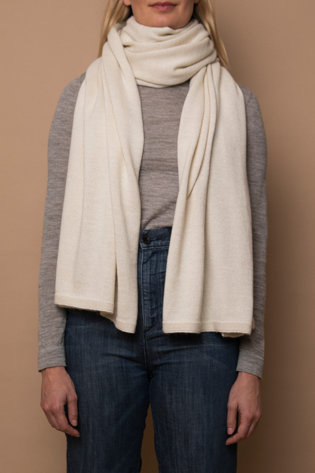 Ivory Vellie wrap styled as a scarf, showcasing its versatile design. A staple in any wardrobe. Ethically made in Peru.