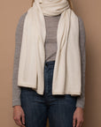 Ivory Vellie wrap styled as a scarf, showcasing its versatile design. A staple in any wardrobe. Ethically made in Peru.