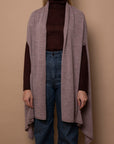 Mauve Vellie wrap worn with arms through armholes showcasing its luxurious 100% fair-trade baby alpaca fiber, an heirloom quality piece known for it’s exceptional warmth and timelessness.