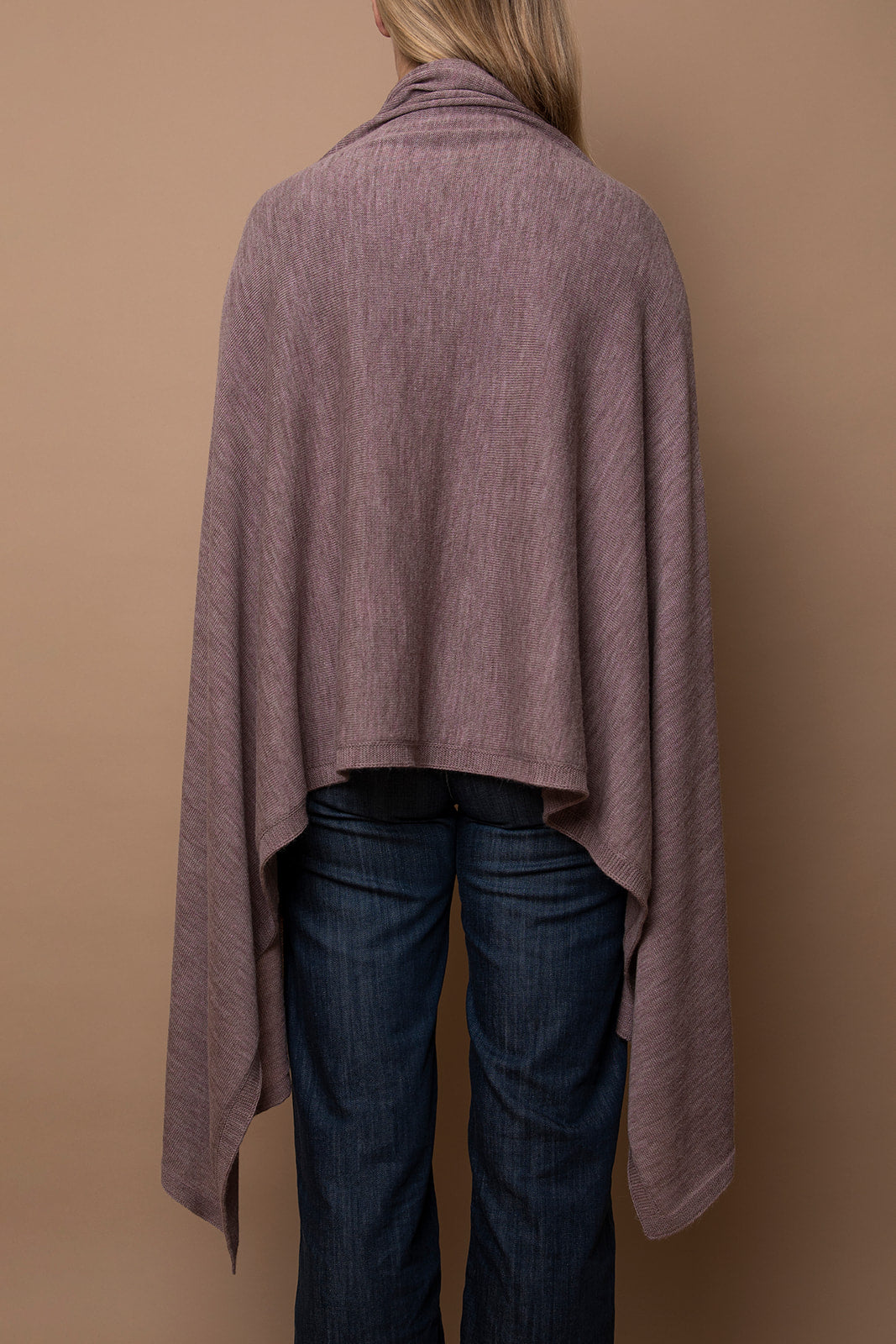 Back view of mauve Vellie wrap with a high-low design, featuring its luxurious 100% fair-trade baby alpaca fiber and elegant, flowing drape. Ethically made in Peru.