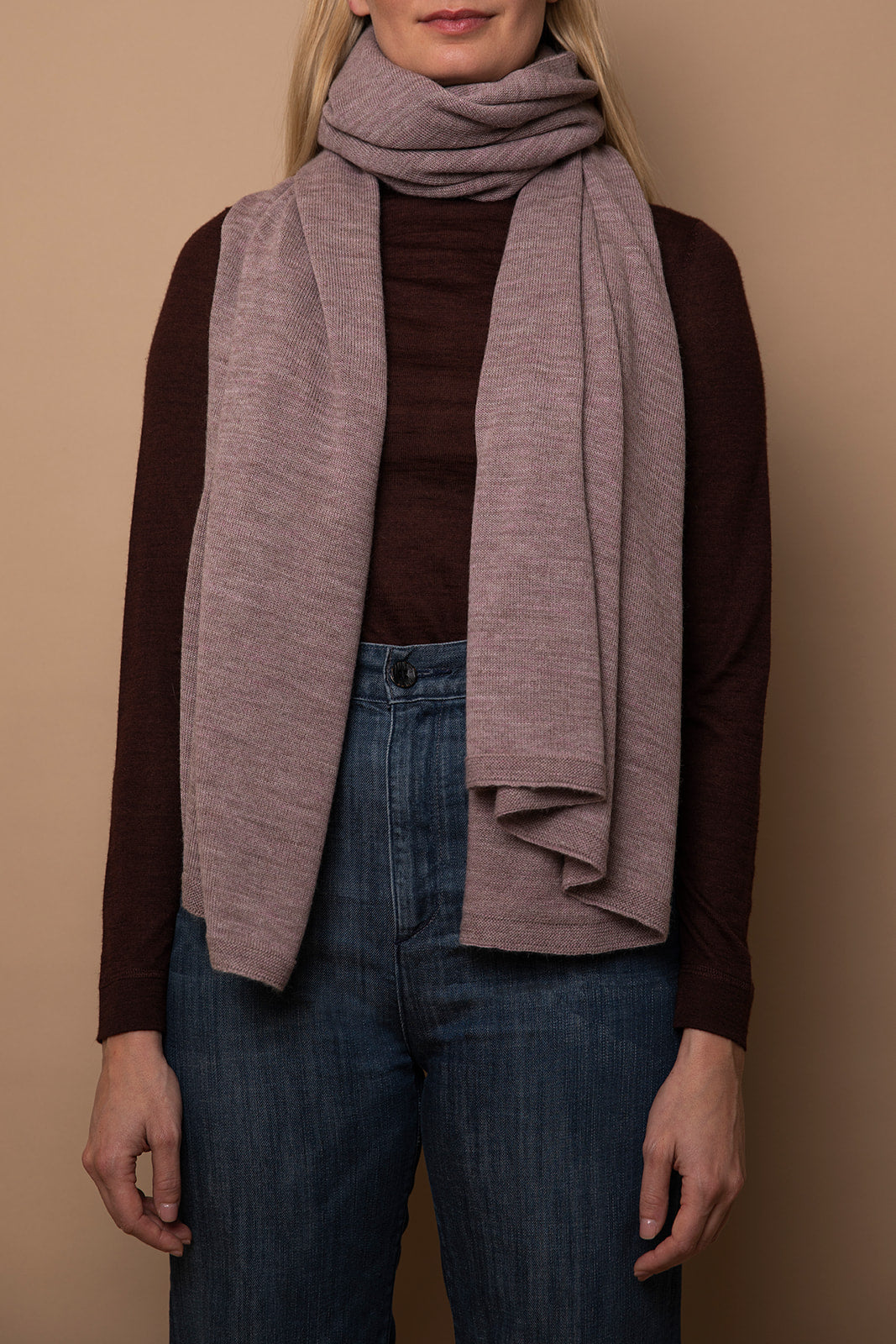 Mauve Vellie wrap styled as a scarf, showcasing its versatile design. Made from sustainably sourced baby alpaca fibers. RAS (Responsible Alpaca Standard), Fair Trade Peru, Oeko-Tex Standard 100 certified.