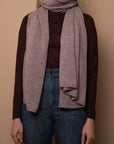 Mauve Vellie wrap styled as a scarf, showcasing its versatile design. Made from sustainably sourced baby alpaca fibers. RAS (Responsible Alpaca Standard), Fair Trade Peru, Oeko-Tex Standard 100 certified.