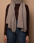 Oat Vellie wrap styled as a scarf, offering cozy warmth and sustainable elegance, made from 100% fair-trade baby alpaca fiber for a chic, versatile look.