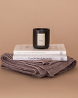 A Lovely Day Gift bundle. Products stacked here: Mauve Vellie Wrap at the bottom, two Brianna Wiest books and a Vellie Candle in the scent Hope.