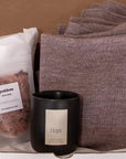 Inside of Imagine Gift Set. Inside, Goddess bath soak by The Bohemian Box Shop, a luxury candle in the scent Hope and a mauve wrap made from ethically sourced baby alpaca.