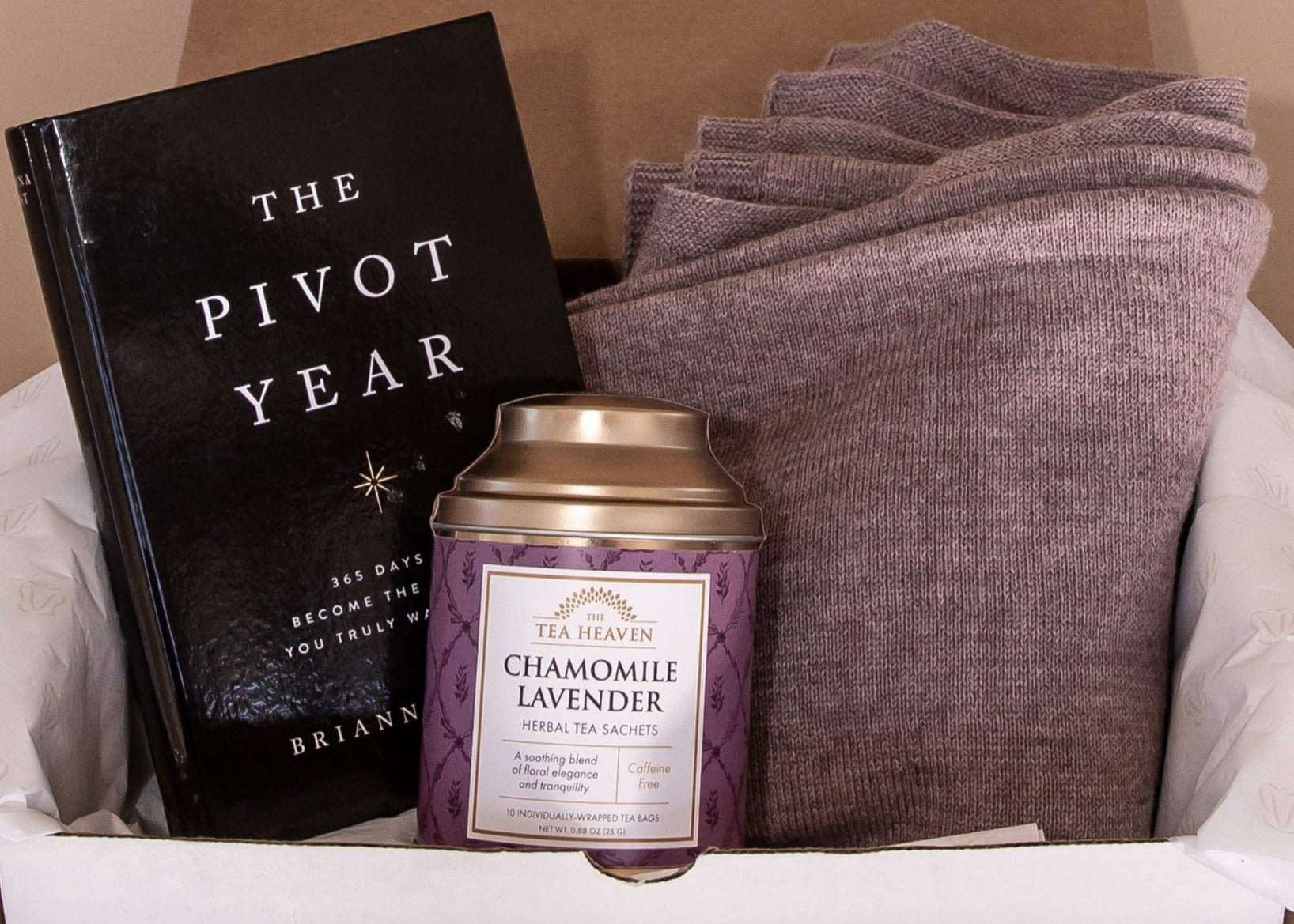 Unboxing of gift bundle inside is the book The Pivot Year, Chamomile Lavender herbal tea by Tea Heaven and the mauve Vellie Wrap.