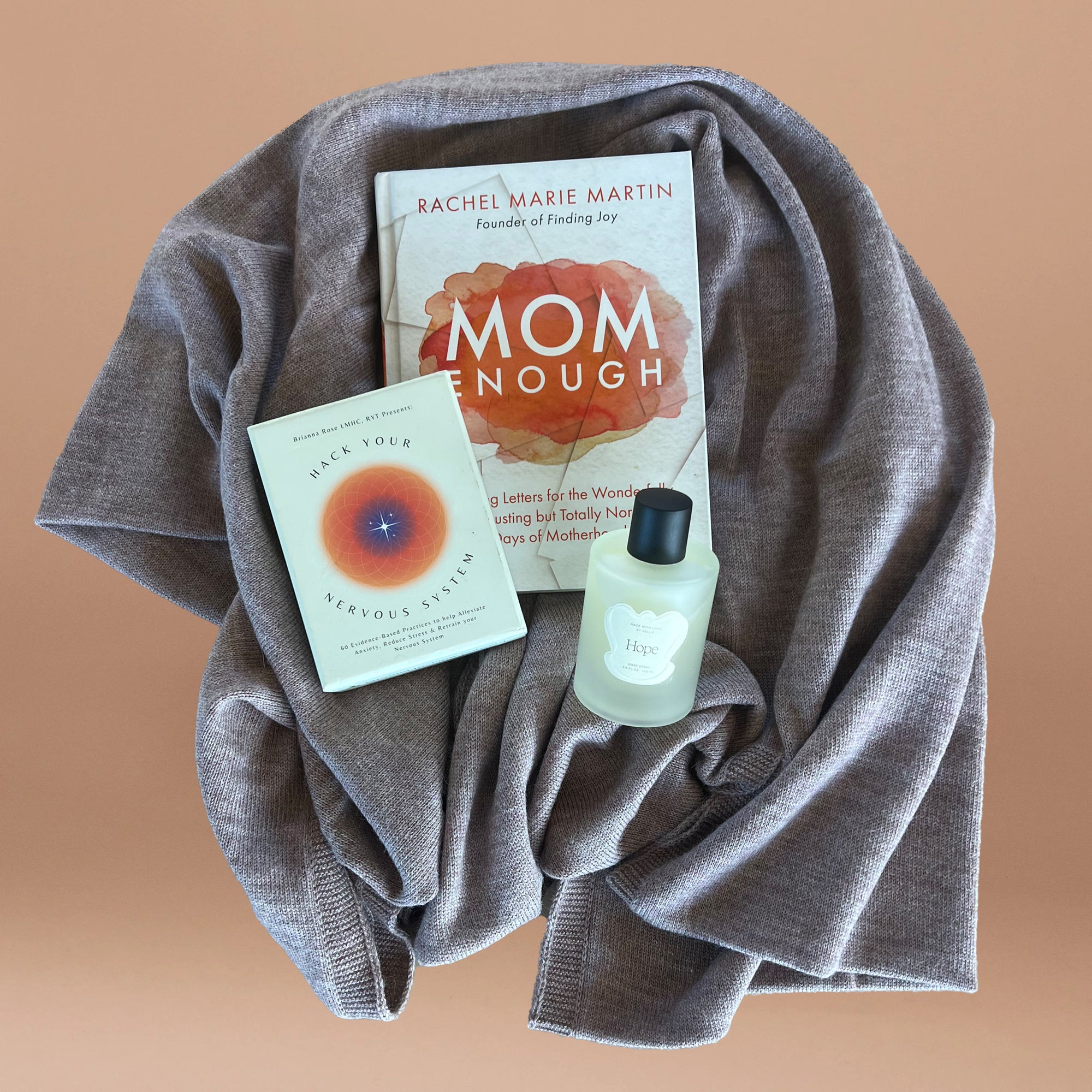 A bundle for mothers includes Mom Enough Book, Hack your Nervous System Deck, Hope Wrap Spray and a beautiful baby alpaca wrap.