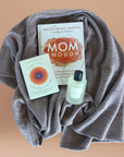 A bundle for mothers includes Mom Enough Book, Hack your Nervous System Deck, Hope Wrap Spray and a beautiful baby alpaca wrap.