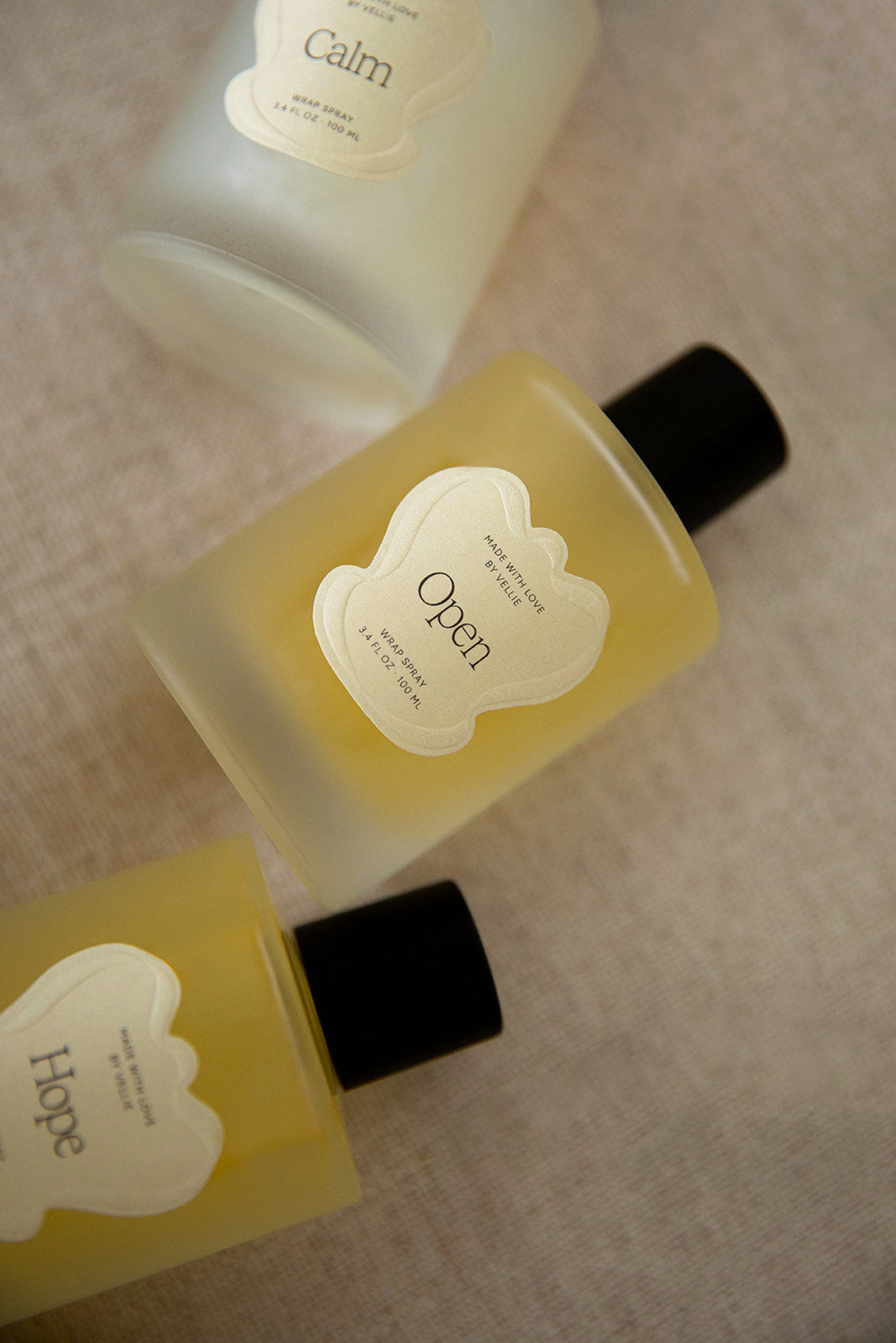 Three Vellie Wrap Sprays displayed together, each crafted with the finest raw materials and expertly blended by a Paris-trained Seattle-based Master Perfumer. Handmade by women with love.