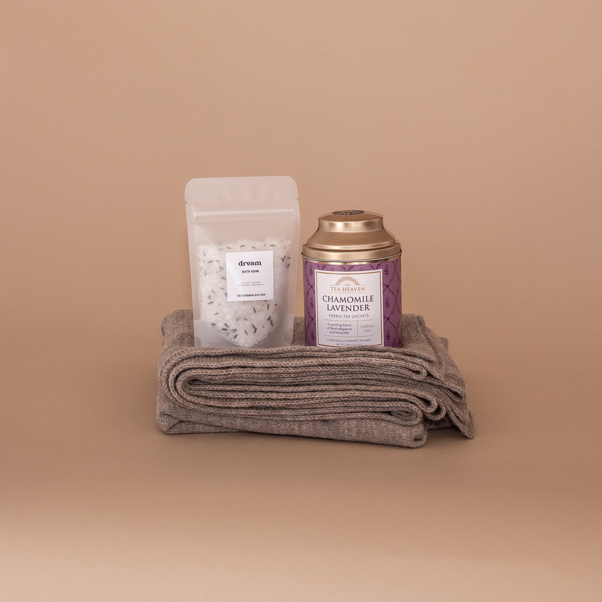 Soulshine Gift Bundle. Folded at the bottom is an oat wrap made from 100% baby alpaca and on top Dream Bath Soak by The Bohemian Box Shop and Chamomile Lavender tea by Tea Heaven.