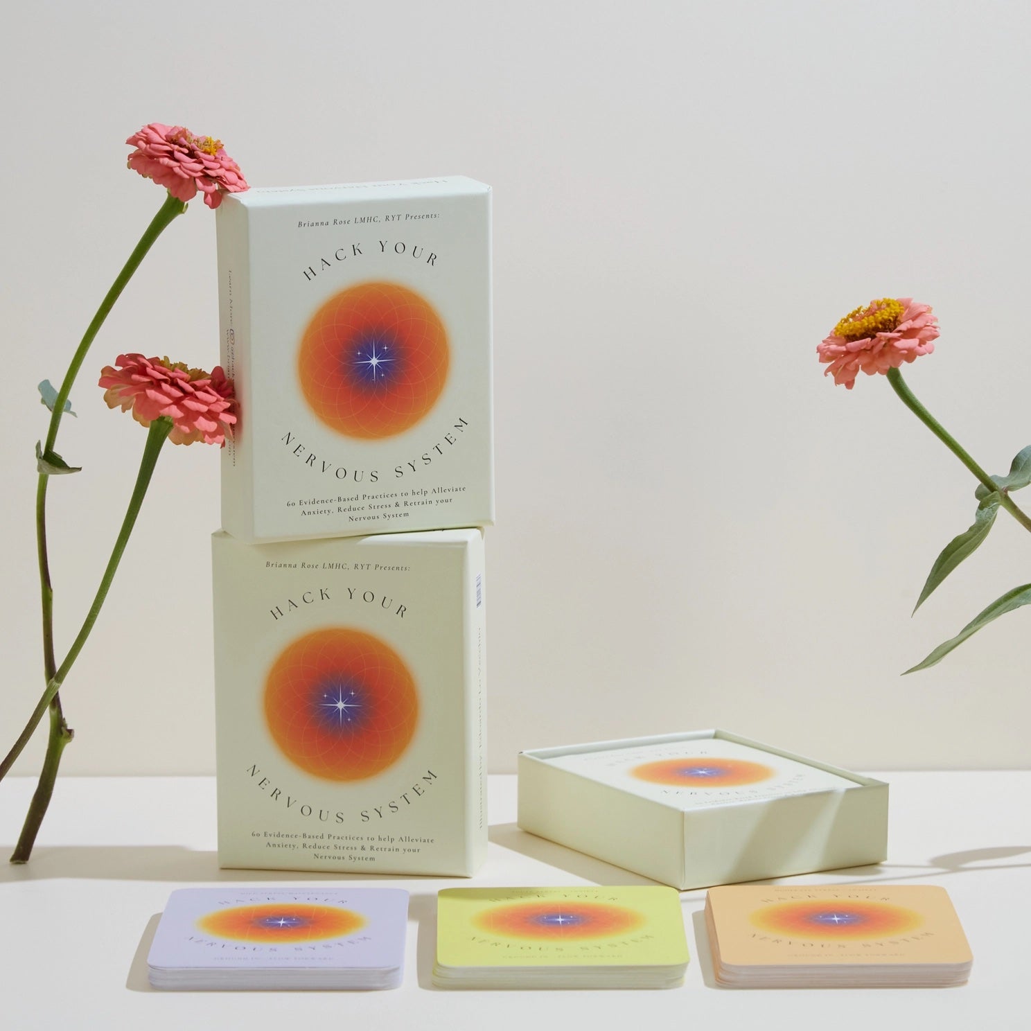 Card deck titled &#39;Hack Your Nervous System&#39; with flowers on a light background