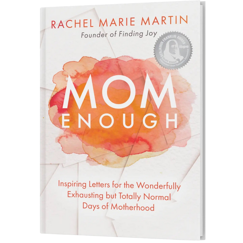 Cover of 'Mom Enough,' a heartfelt book by Rachel Martin, featuring a watercolor design in orange and pink hues with the title text. The book celebrates motherhood and encourages moms to embrace their imperfections.