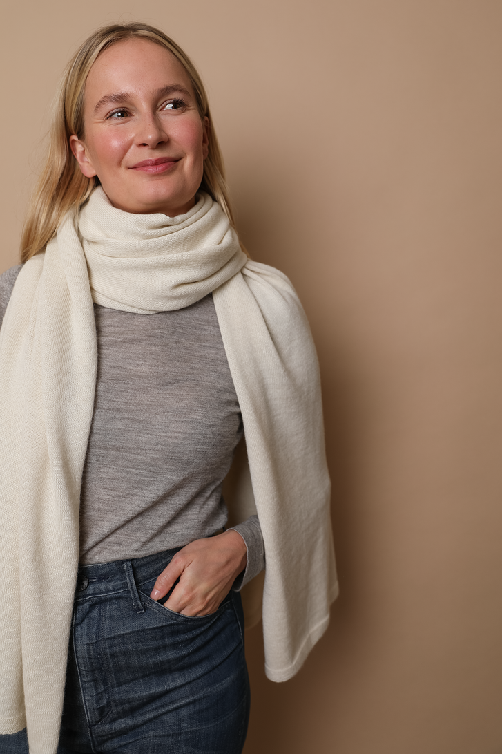 Model wearing an Ivory wrap. Made from 100% fair-trade baby alpaca fiber. Styled here as a scarf. 