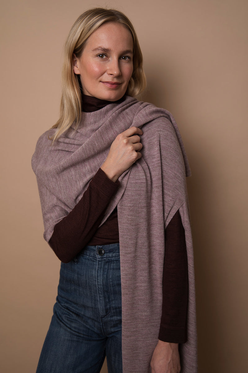 Model wearing a mauve colored wrap. Made from 100% fair-trade baby alpaca fiber. Draped over one shoulder, ethically crafted from 100% fair-trade baby alpaca fiber.